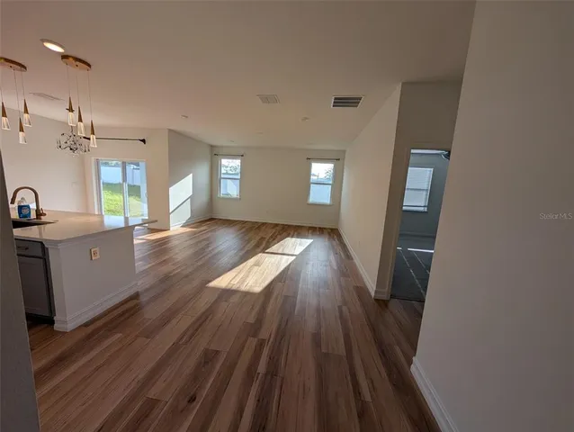 a kitchen with wooden floor and a stove top oven