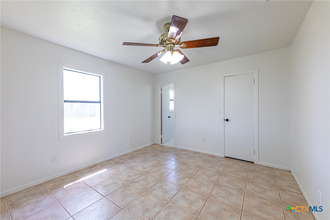 985 County Road 301 Shiner, TX 77984 - Photo 13 of 31 a view of an empty room with window and chandelier fan