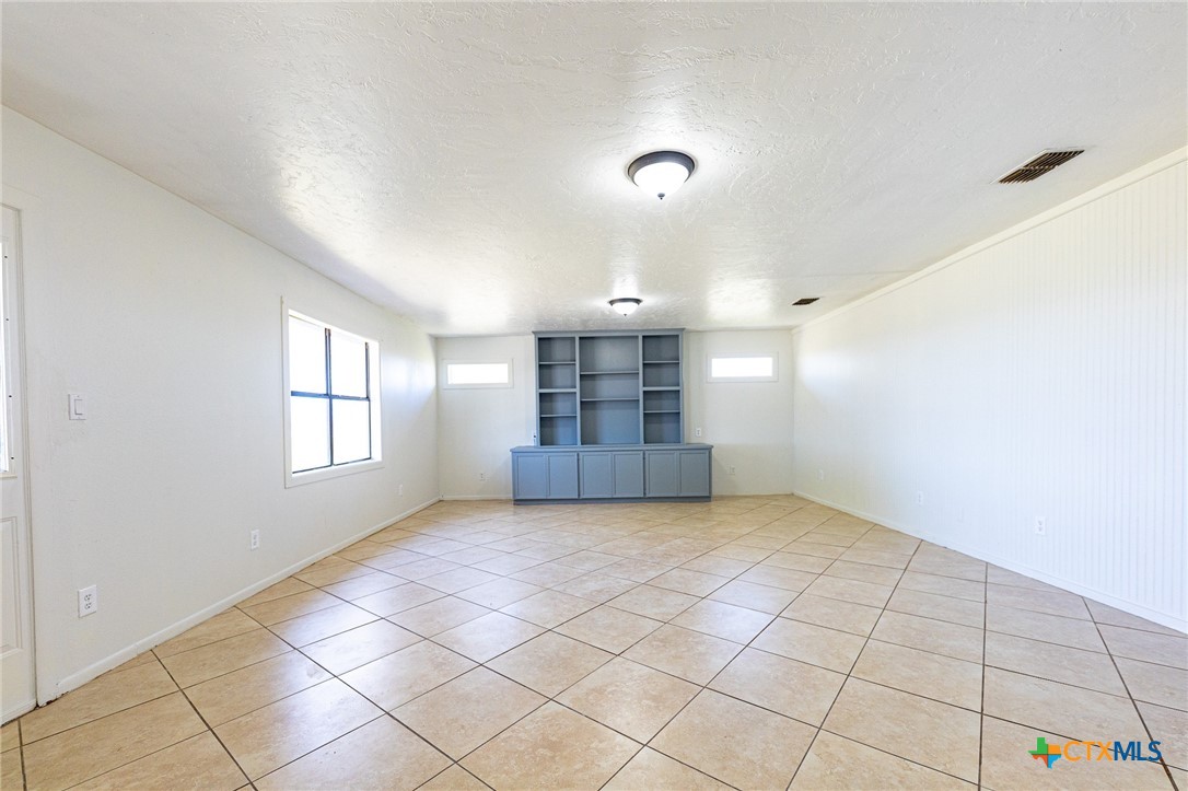 985 County Road 301 Shiner, TX 77984 - Photo 7 of 31 an empty room with windows and cabinet