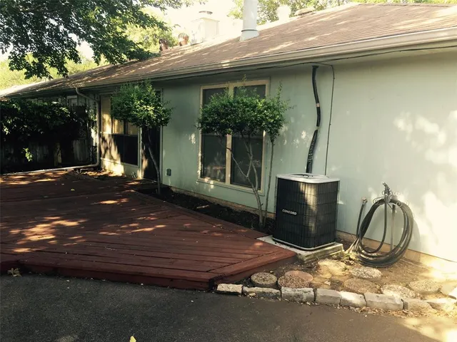 a backyard of a house with table and chairs