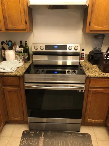 a stove top oven sitting inside of a kitchen