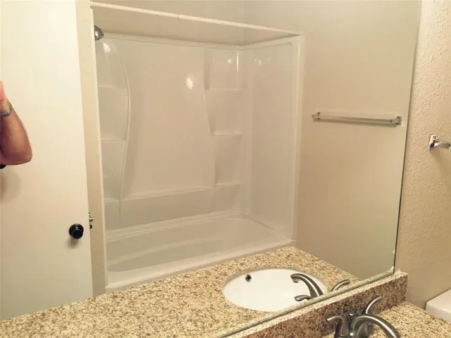 a bathroom with a sink and a shower