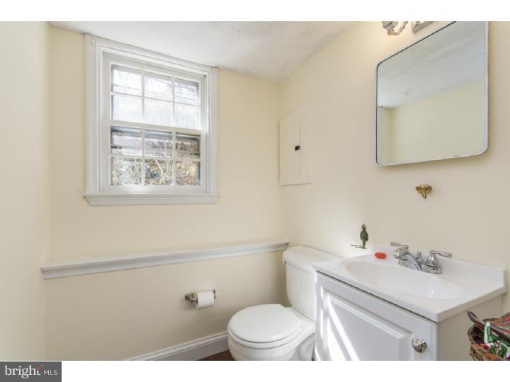 262 Devonshire Road Devon, PA 19333 - Photo 19 of 23 a bathroom with a sink vanity mirror and toilet