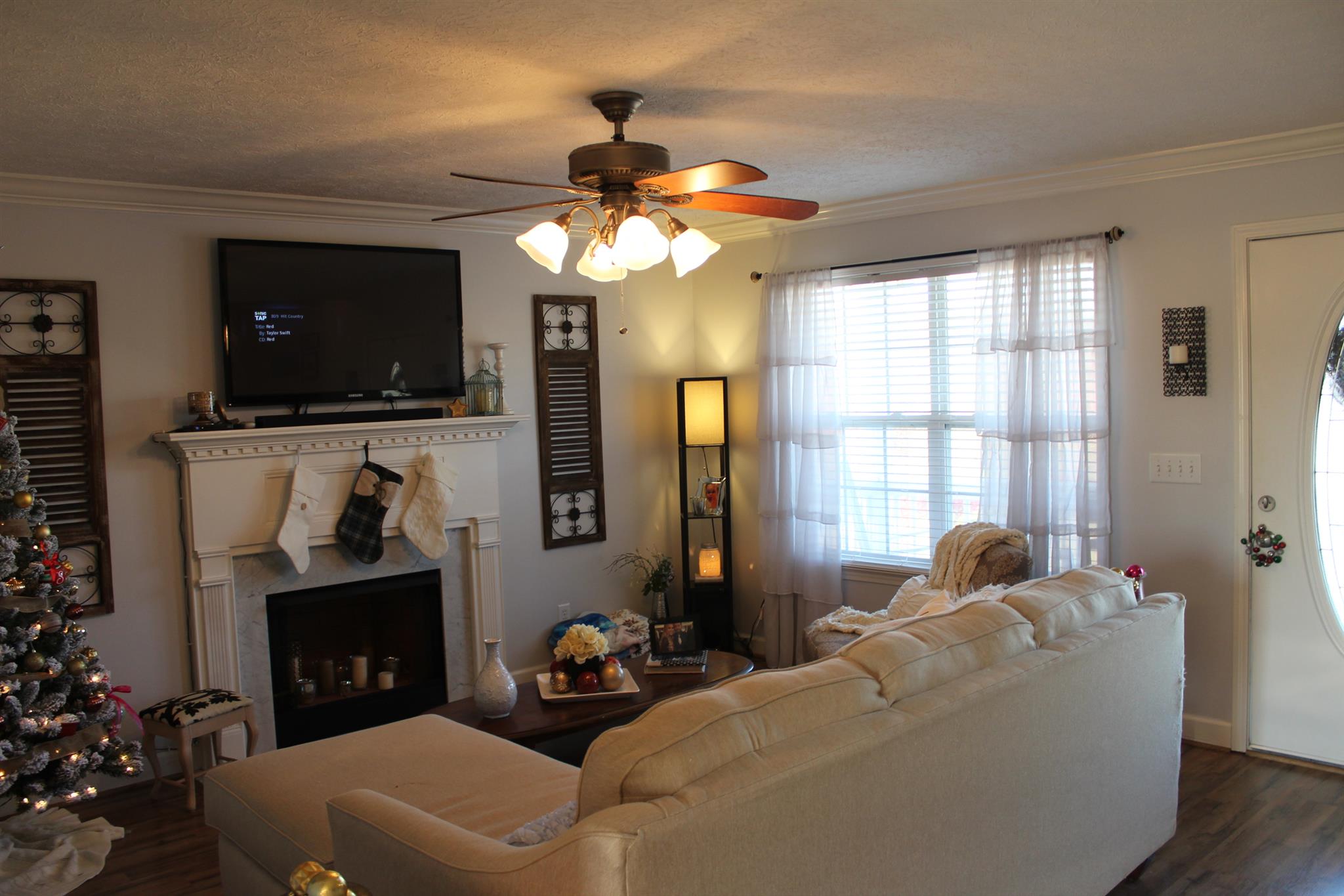 525 Martin Chapel Road Portland, TN 37148 - Photo 11 of 29 a living room with furniture a flat screen tv and a fireplace