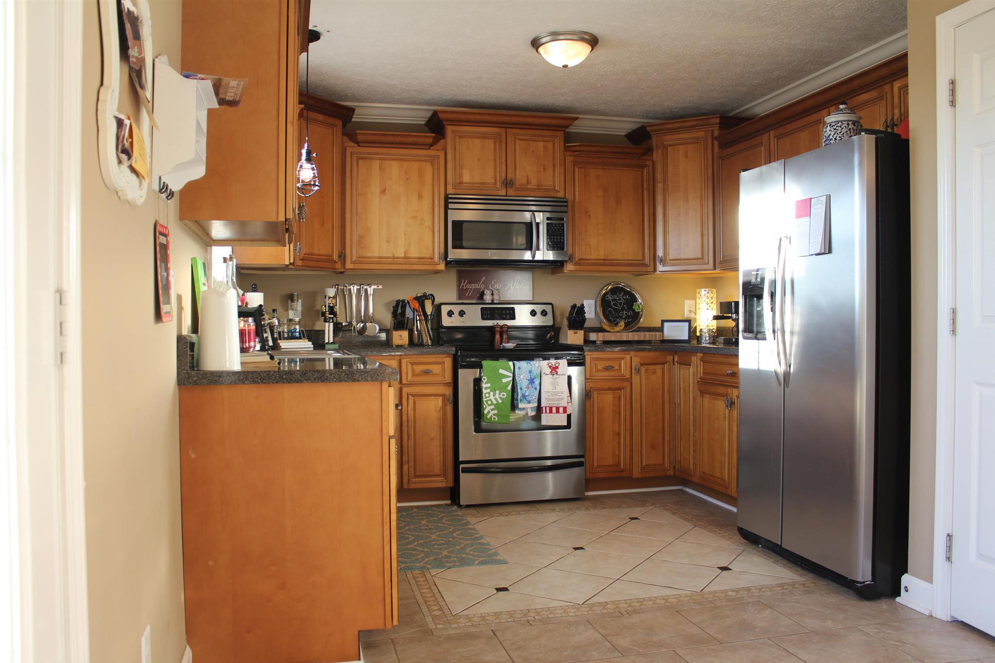 525 Martin Chapel Road Portland, TN 37148 - Photo 13 of 29 a kitchen with stainless steel appliances granite countertop a refrigerator and a stove top oven