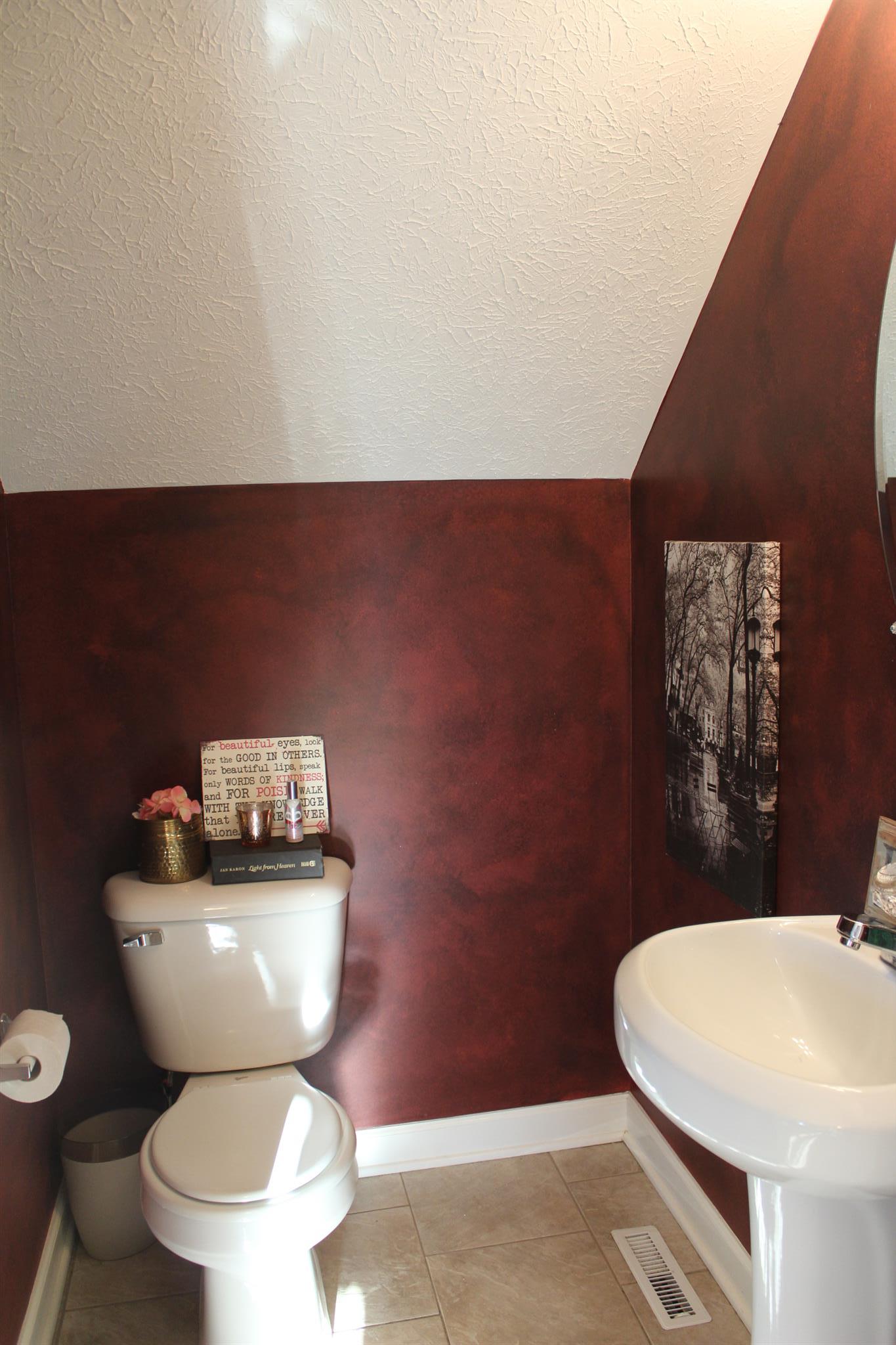 525 Martin Chapel Road Portland, TN 37148 - Photo 15 of 29 a white toilet sitting next to a bathroom sink and a mirror