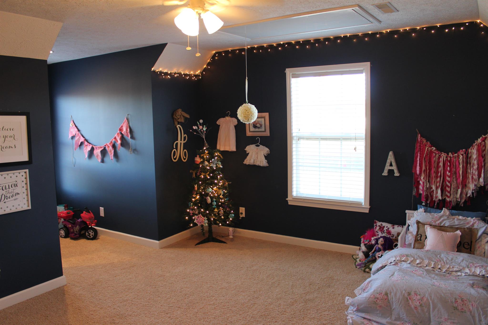 525 Martin Chapel Road Portland, TN 37148 - Photo 23 of 29 a bed room with a bed a chandelier and a window