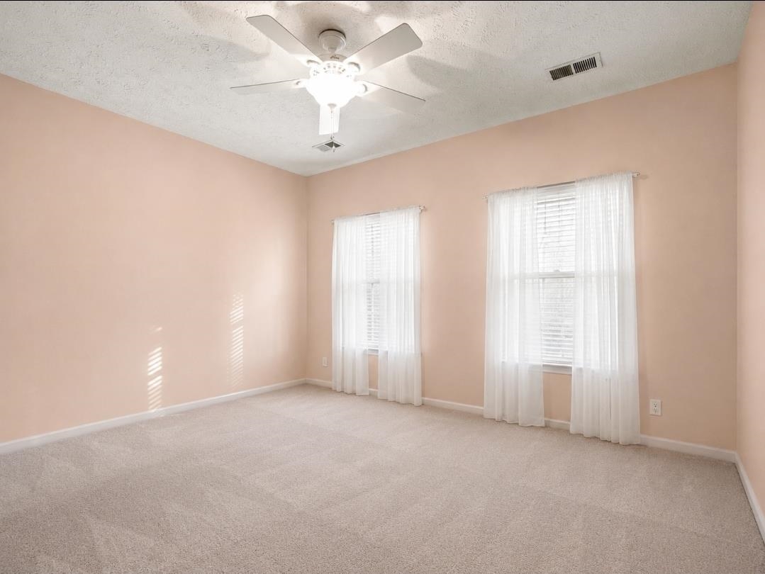 3779 Dancyville Road Stanton, TN 38069 - Photo 6 of 22 Spacious room featuring neutral carpeting, light-toned walls, and a ceiling fan with integrated lighting
