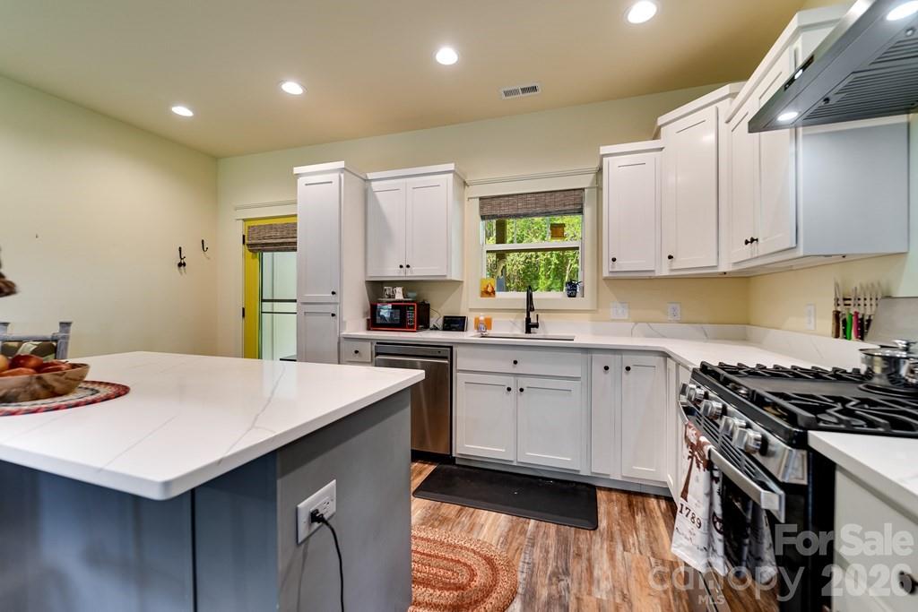 190 Fort Hembree Road Hayesville, NC 28904 - Photo 10 of 18 a kitchen with stainless steel appliances a sink a stove a refrigerator and cabinets