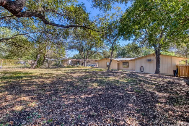 a view of a house with a backyard