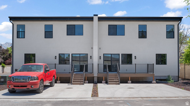 7238 South 525 East Midvale, UT 84047 - Photo 27 of 29 Contemporary exterior facade featuring light-colored stucco, black trim, and dark-framed windows
