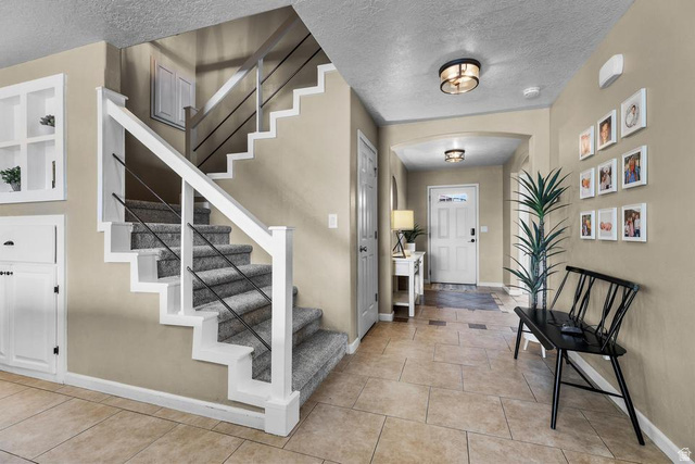 225 Falcon Court Ivins, UT 84738 - Photo 19 of 47 Entrance foyer featuring a textured ceiling, arched walkways, and light tile patterned flooring