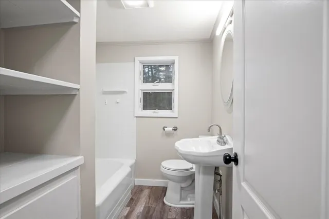 a bathroom with a sink toilet and a mirror