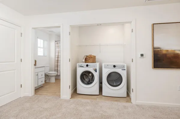 a spacious bedroom with a bed and a sink