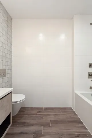 a bathroom with a sink a toilet and mirror