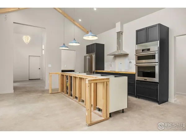 a kitchen with stainless steel appliances granite countertop a stove refrigerator and cabinets