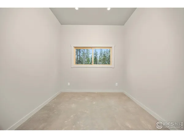 a spacious bedroom with a bed and a window