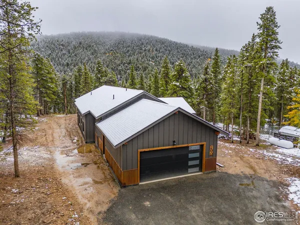 a aerial view of a house next to a yard