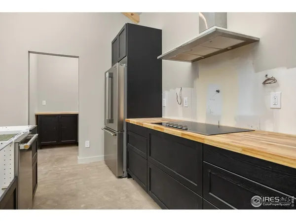 a large kitchen with cabinets and stainless steel appliances