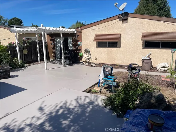 a group of people sitting in front of a house