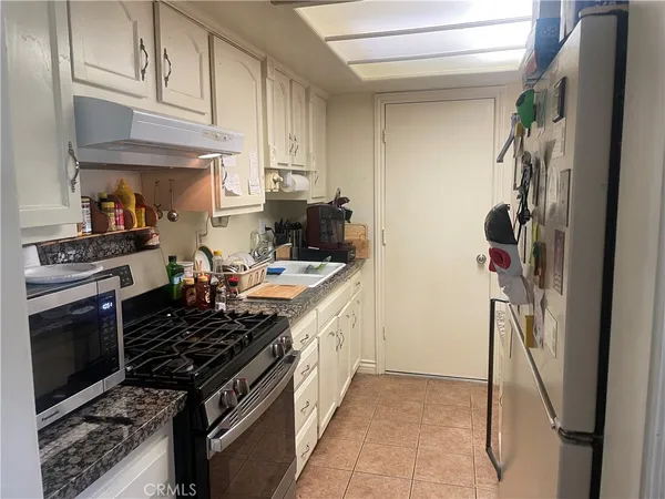 a kitchen with stainless steel appliances granite countertop a stove and a refrigerator