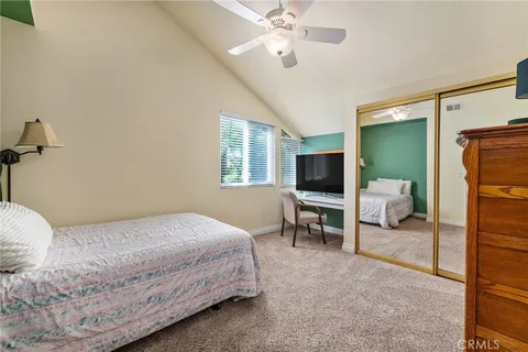 an aerial view of ocean and residential houses with outdoor space