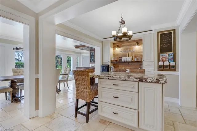 a view of a hallway with furniture and a chandelier
