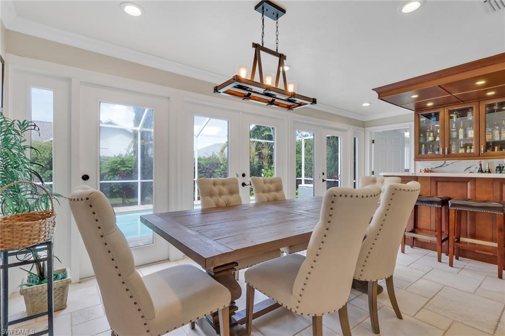 431 Ibis Way Naples, FL 34110 - Photo 13 of 37 a view of a dining room with furniture window and wooden floor