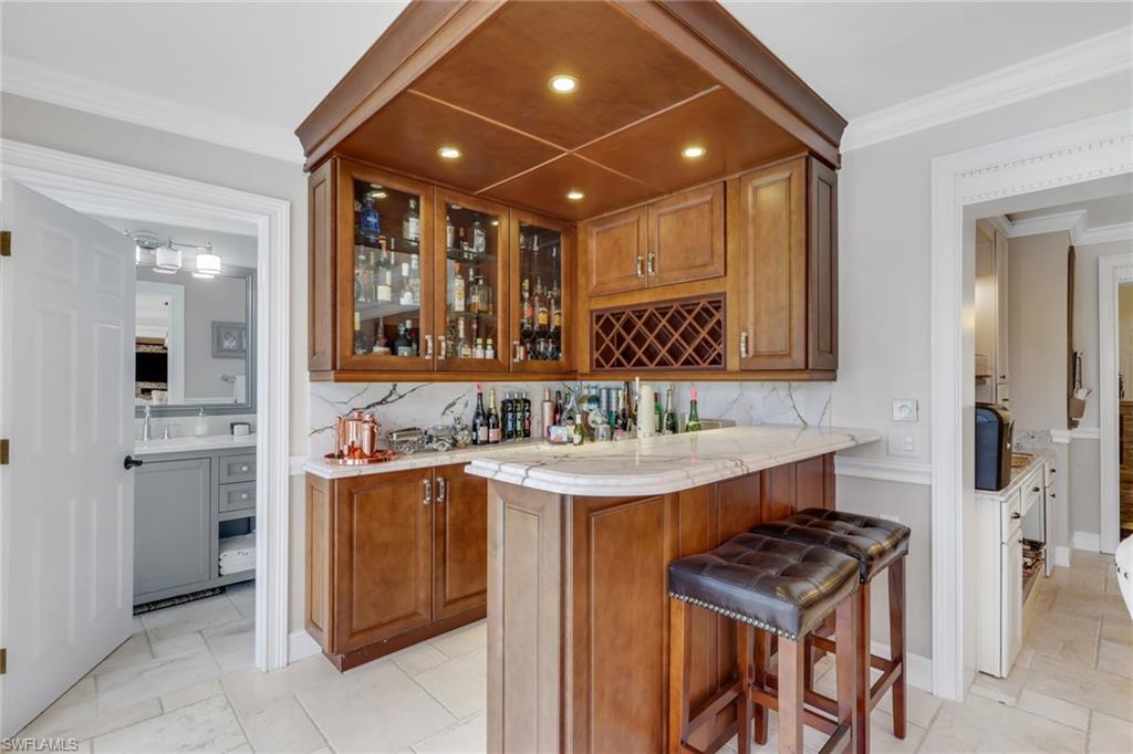 431 Ibis Way Naples, FL 34110 - Photo 15 of 37 a bathroom with a sink a toilet and mirror