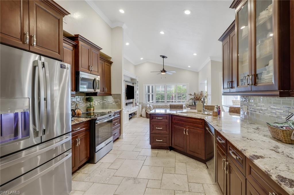 431 Ibis Way Naples, FL 34110 - Photo 22 of 37 a large kitchen with stainless steel appliances granite countertop a refrigerator and a sink