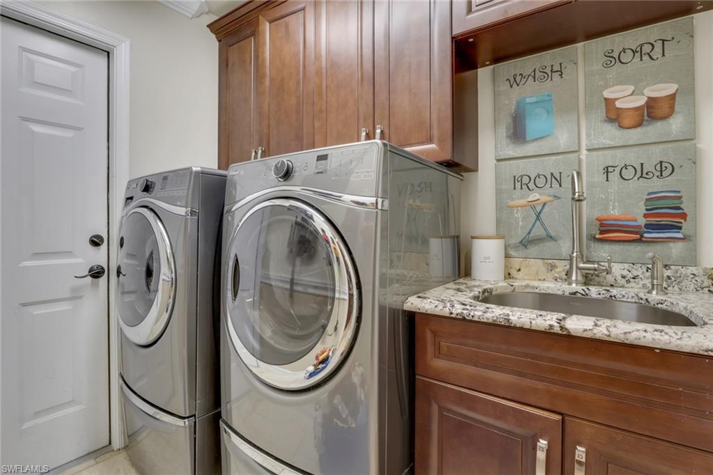 431 Ibis Way Naples, FL 34110 - Photo 23 of 37 a utility room with dryer and washer