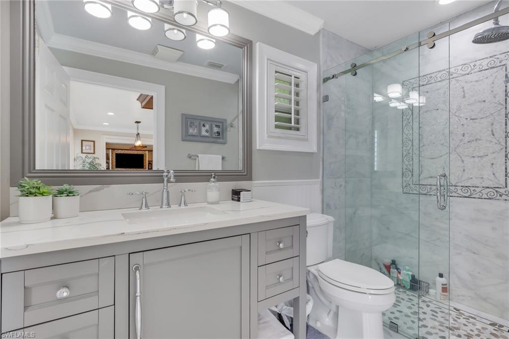 431 Ibis Way Naples, FL 34110 - Photo 24 of 37 a bathroom with a sink a toilet and shower