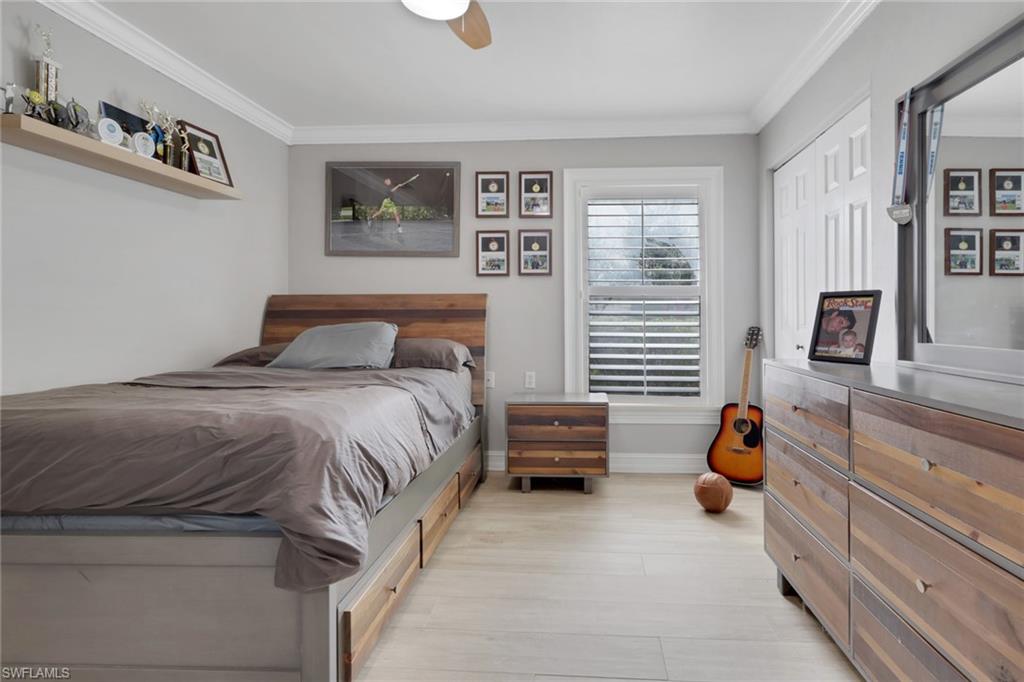 431 Ibis Way Naples, FL 34110 - Photo 25 of 37 a bedroom with a bed and a window