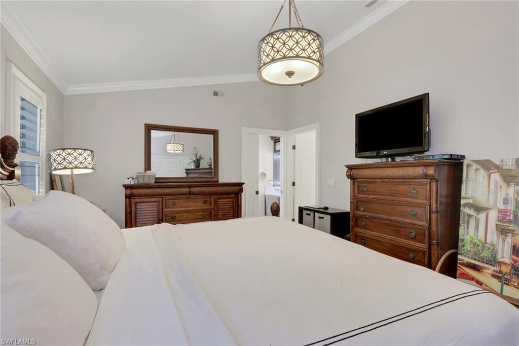 431 Ibis Way Naples, FL 34110 - Photo 29 of 37 a bedroom with a bed and a flat screen tv