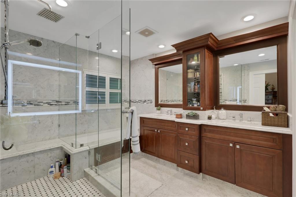431 Ibis Way Naples, FL 34110 - Photo 30 of 37 a bathroom with a double vanity sink mirror and shower