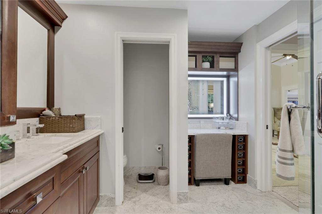 431 Ibis Way Naples, FL 34110 - Photo 32 of 37 a bathroom with a granite countertop sink and a mirror