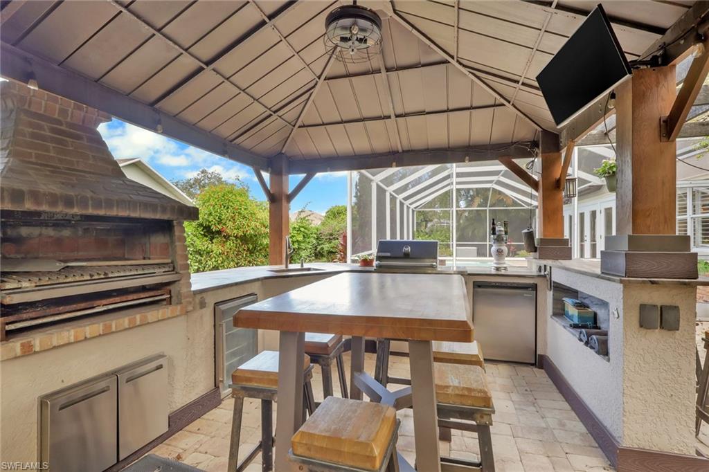 431 Ibis Way Naples, FL 34110 - Photo 37 of 37 a kitchen with stainless steel appliances granite countertop a stove a sink and a refrigerator