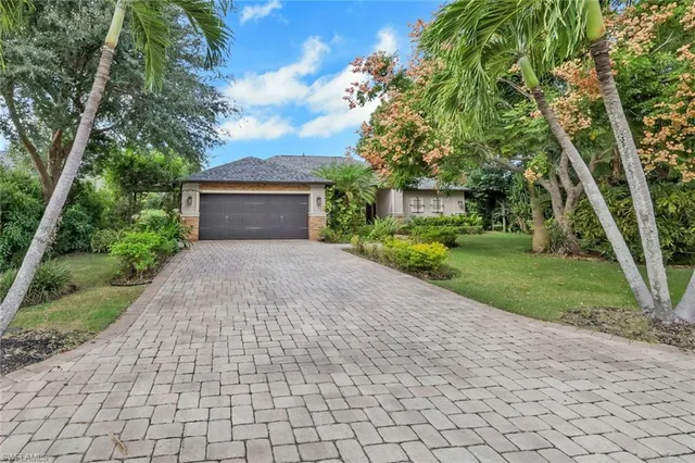 a front view of a house with a yard and a garage