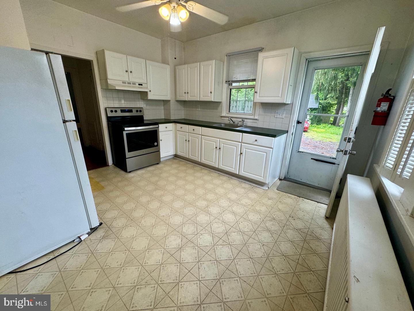 74 South Main Street, Unit A Mullica Hill, NJ 08062 - Photo 4 of 4 a kitchen with stainless steel appliances a stove a sink a refrigerator a window a sink and a refrigerator