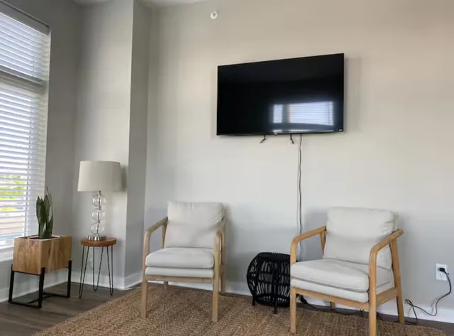 a living room with furniture and a flat screen tv