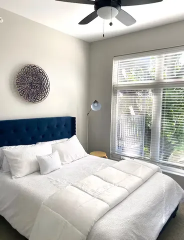 a bedroom with a large bed and a large window