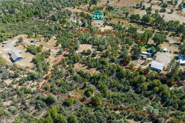 an aerial view of a houses with a yard
