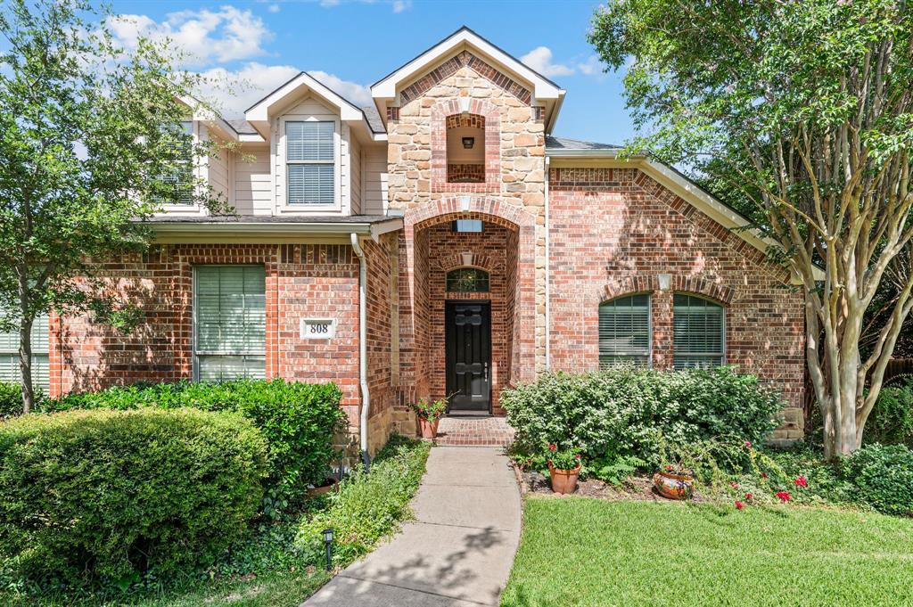 808 Briar Ridge Drive Keller, TX 76248 - Photo 3 of 40 Brick and stone facade featuring an arched entry, multiple gables, and a concrete pathway
