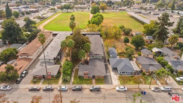 an aerial view of residential houses with outdoor space and swimming pool