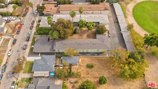 an aerial view of residential houses with outdoor space