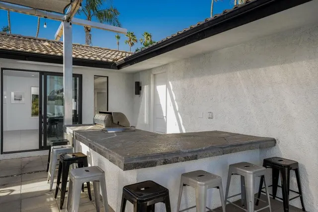 a view of a house with backyard porch and sitting area