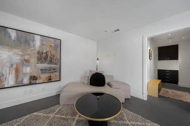 an aerial view of a house with a garden and mountain view