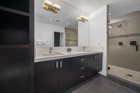 a bathroom with a sink vanity and a mirror