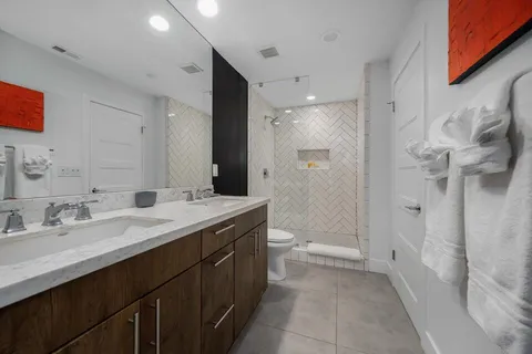 a kitchen with stainless steel appliances granite countertop a table chairs and a view of living room