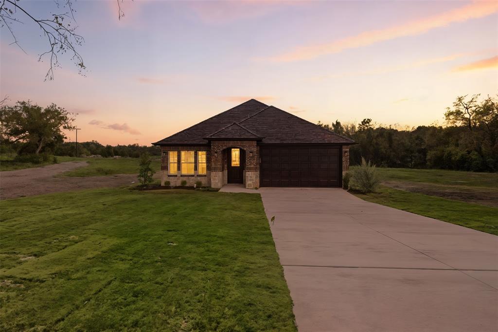 412 Ball Street Tom Bean, TX 75491 - Photo 1 of 28 a front view of a house with a yard